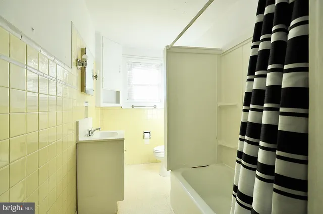 a bathroom with a bathtub and shower