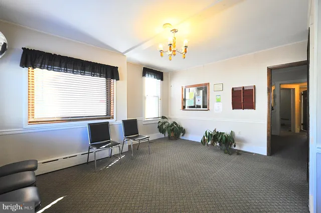 a view of a livingroom with workspace and a window