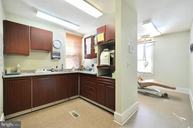 a kitchen with a sink cabinets and window