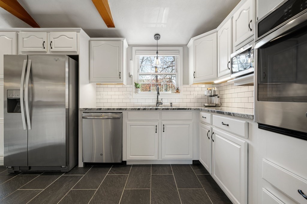 18 Corcoran Road Billerica, MA 01821 - Photo 12 of 40 a kitchen with granite countertop a sink stainless steel appliances and cabinets