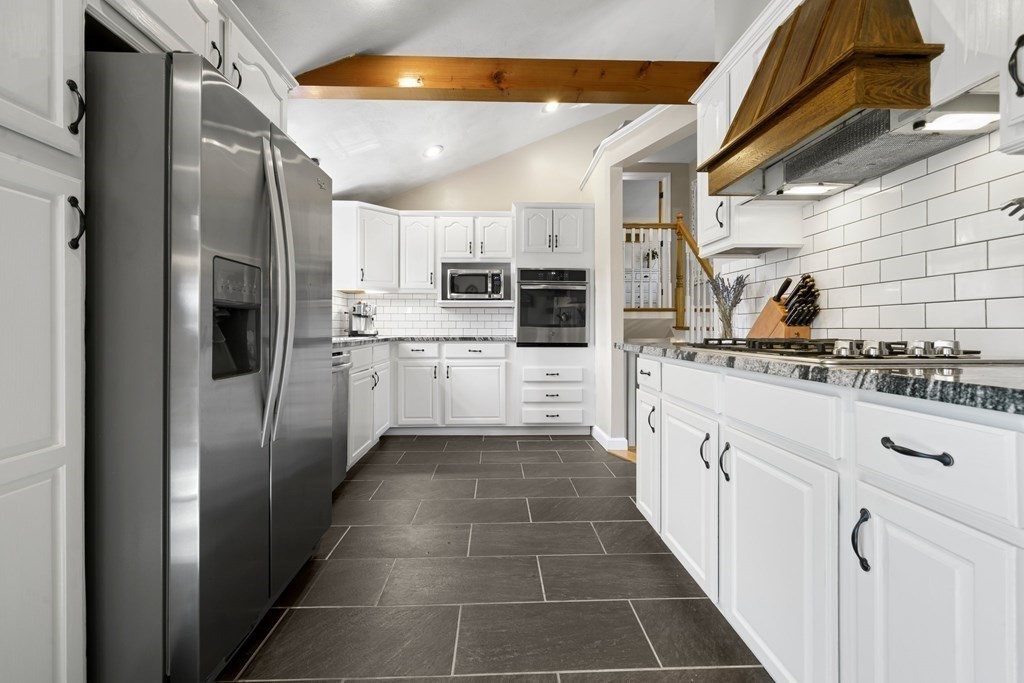 18 Corcoran Road Billerica, MA 01821 - Photo 17 of 40 a kitchen with stainless steel appliances kitchen island granite countertop a refrigerator and a stove top oven
