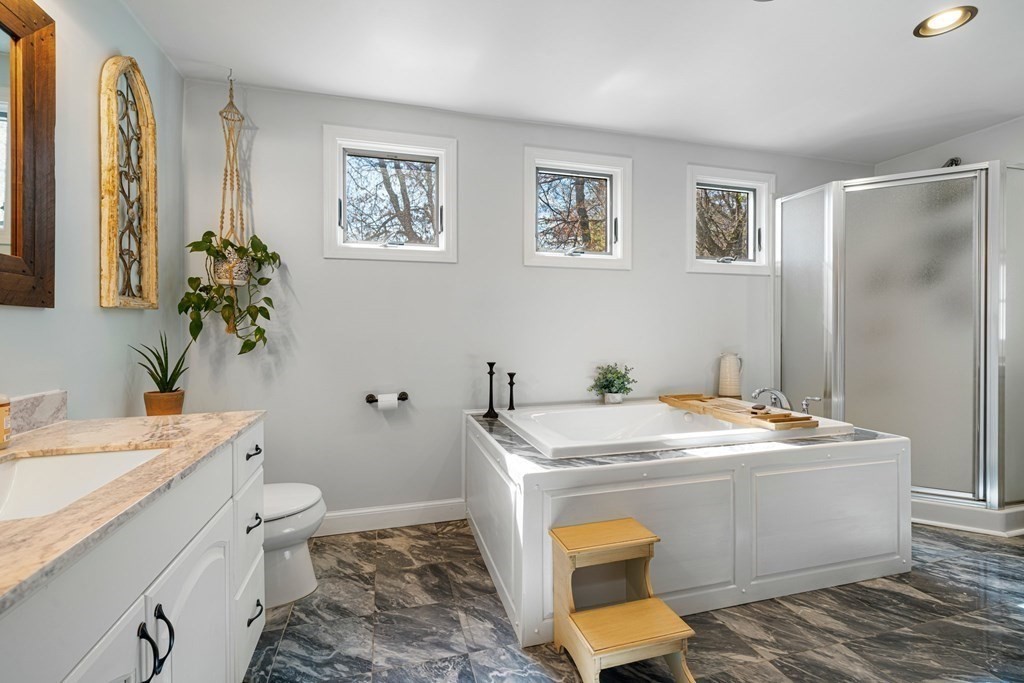 18 Corcoran Road Billerica, MA 01821 - Photo 19 of 40 a room with stainless steel appliances kitchen island a sink stove and view of living room