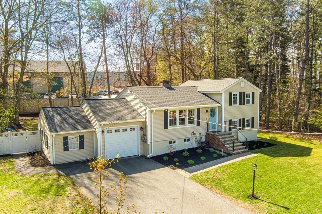 18 Corcoran Road Billerica, MA 01821 - Photo 2 of 40 a front view of a house with a yard patio and a fire pit