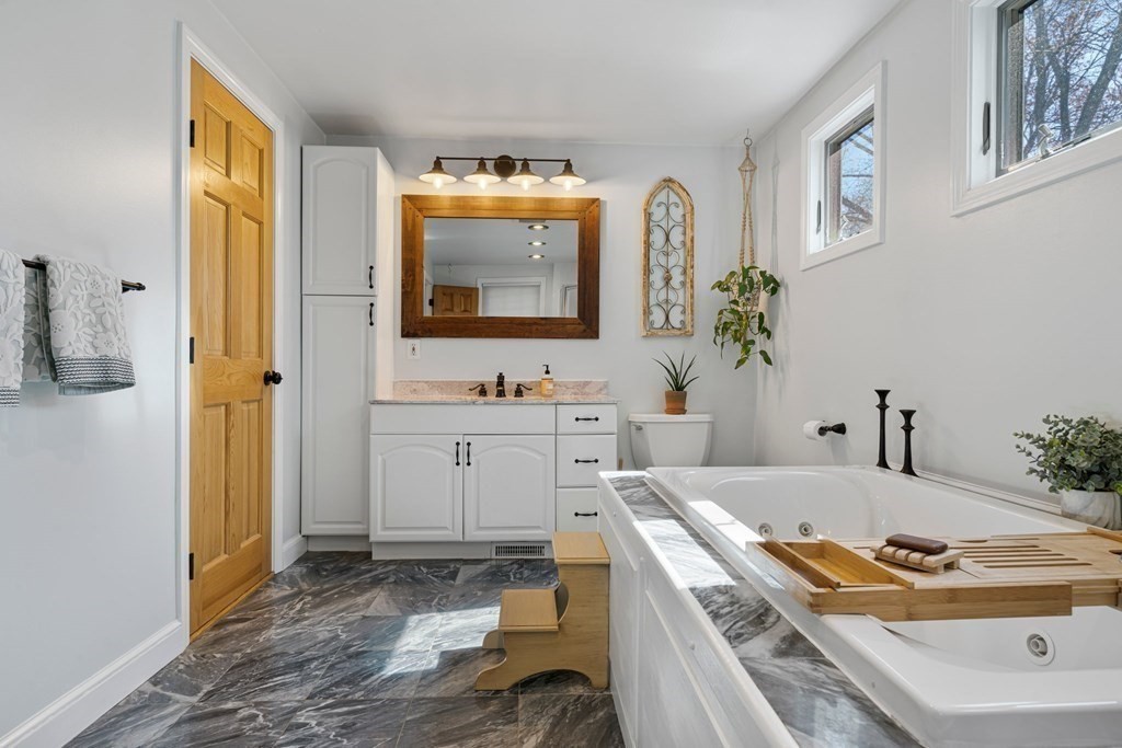 18 Corcoran Road Billerica, MA 01821 - Photo 21 of 40 a bathroom with a tub sink and mirror