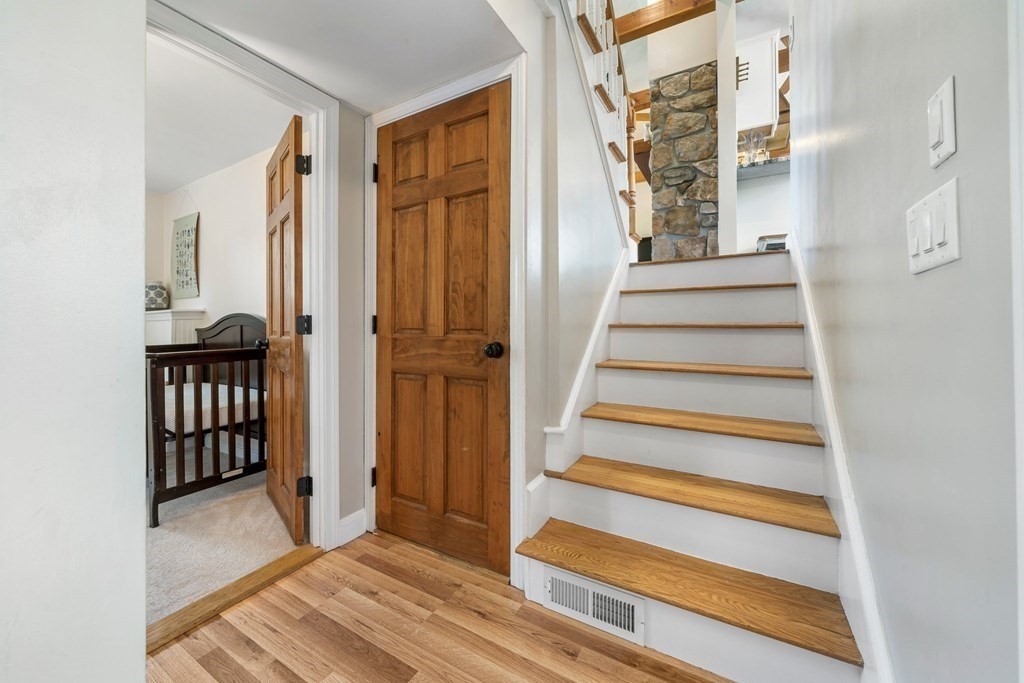 18 Corcoran Road Billerica, MA 01821 - Photo 26 of 40 a view of a hallway with wooden floor and windows