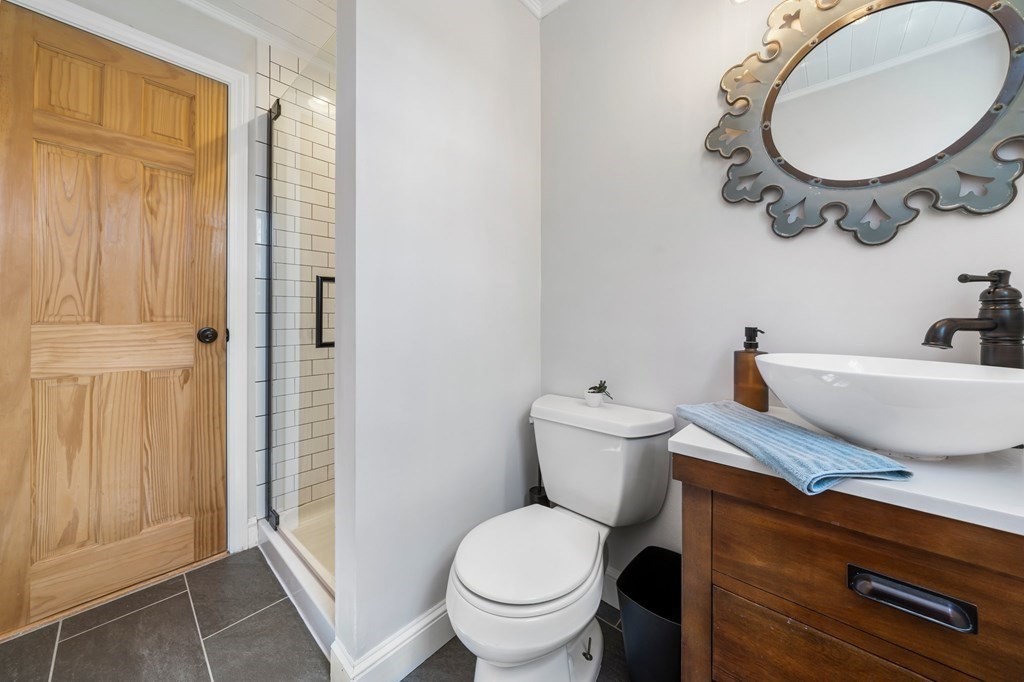 18 Corcoran Road Billerica, MA 01821 - Photo 29 of 40 a bathroom with a toilet a sink and a mirror
