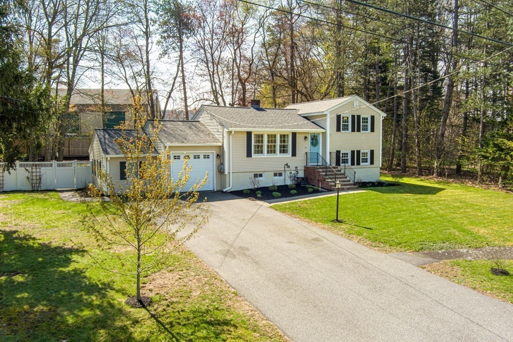 18 Corcoran Road Billerica, MA 01821 - Photo 3 of 40 a view of house with swimming pool and trees in the background