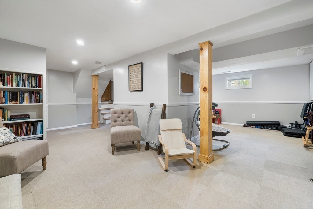 18 Corcoran Road Billerica, MA 01821 - Photo 39 of 40 a living room with furniture and a book shelf