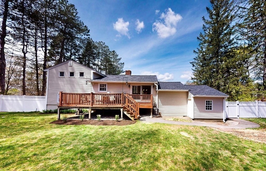 18 Corcoran Road Billerica, MA 01821 - Photo 5 of 40 a front view of a house with a yard fire pit and outdoor seating
