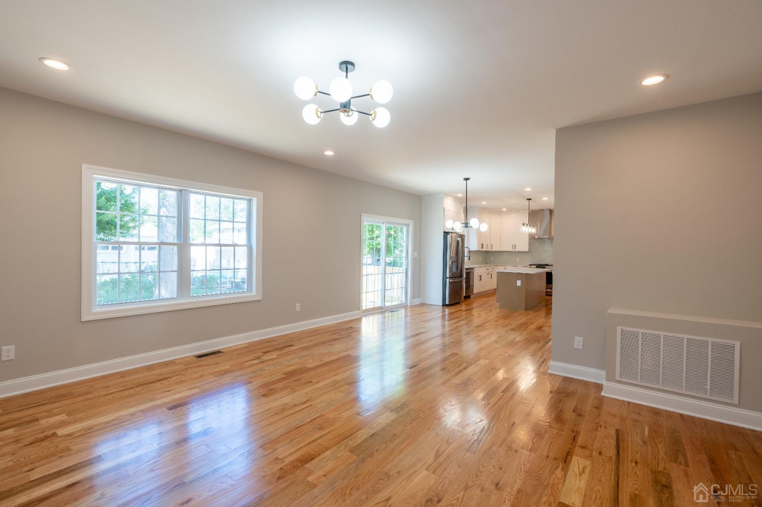 624 New Dover Road Colonia, NJ 07067 - Photo 14 of 29 a view of an empty room with kitchen and wooden floor