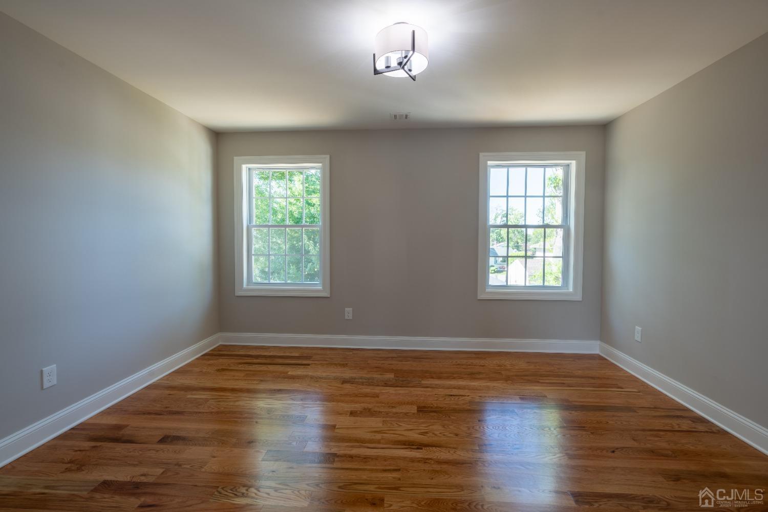 624 New Dover Road Colonia, NJ 07067 - Photo 18 of 29 wooden floor in an empty room with a window