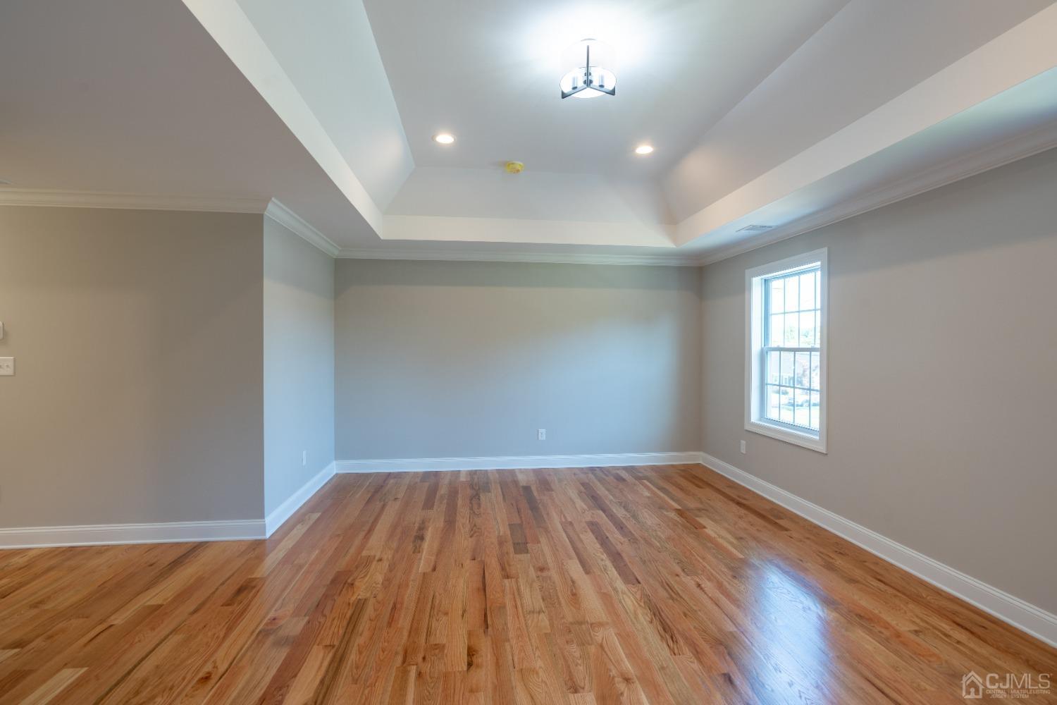 624 New Dover Road Colonia, NJ 07067 - Photo 19 of 29 an empty room with wooden floor and windows