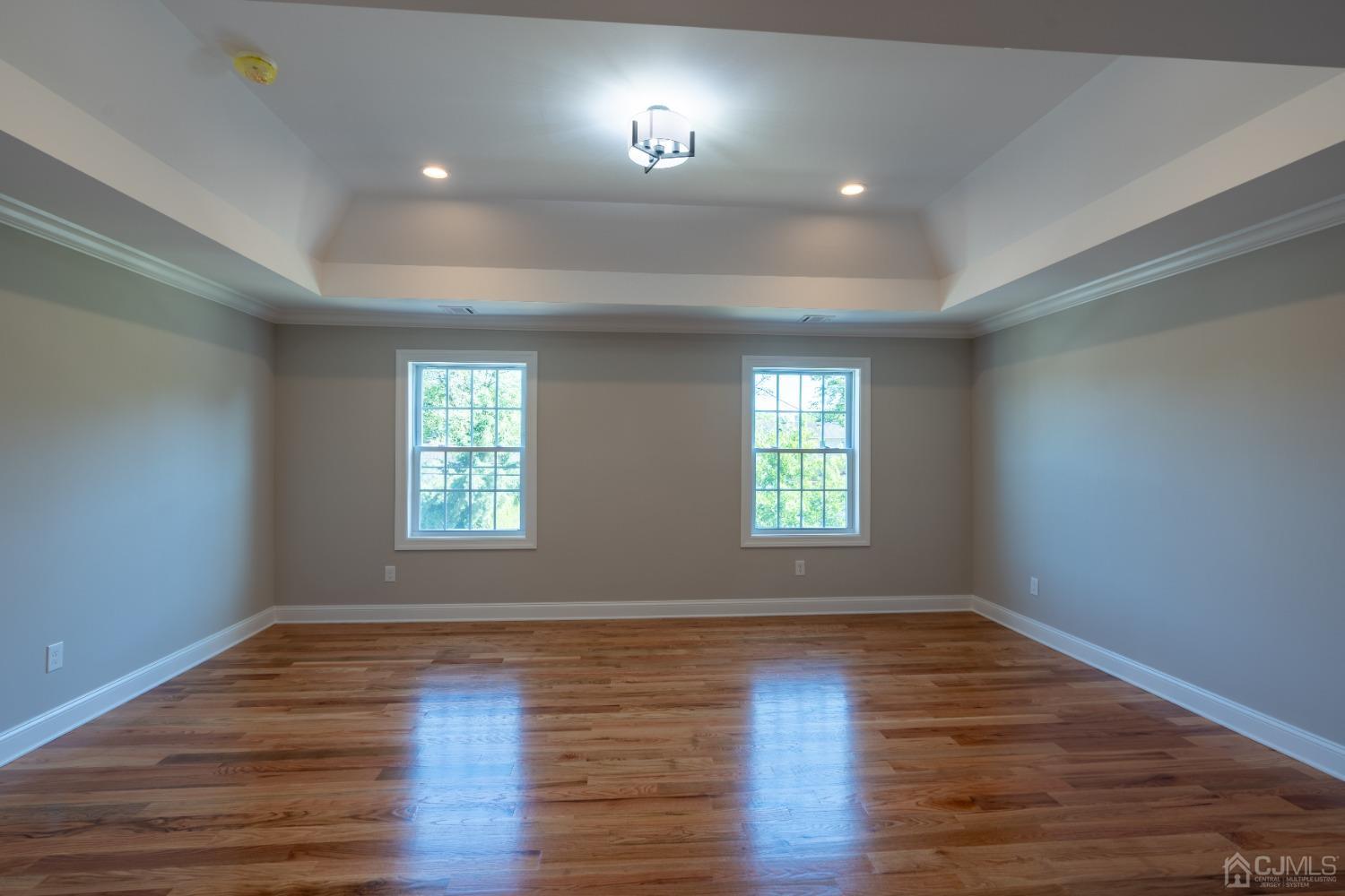 624 New Dover Road Colonia, NJ 07067 - Photo 20 of 29 an empty room with wooden floor and windows