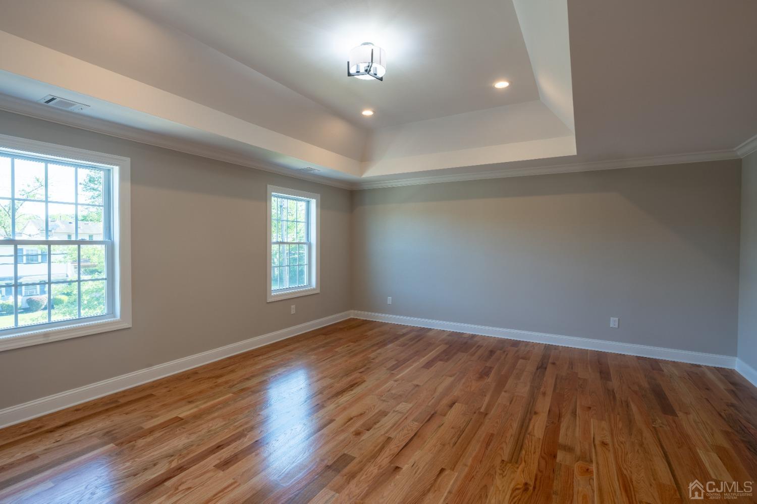 624 New Dover Road Colonia, NJ 07067 - Photo 21 of 29 an empty room with wooden floor and windows