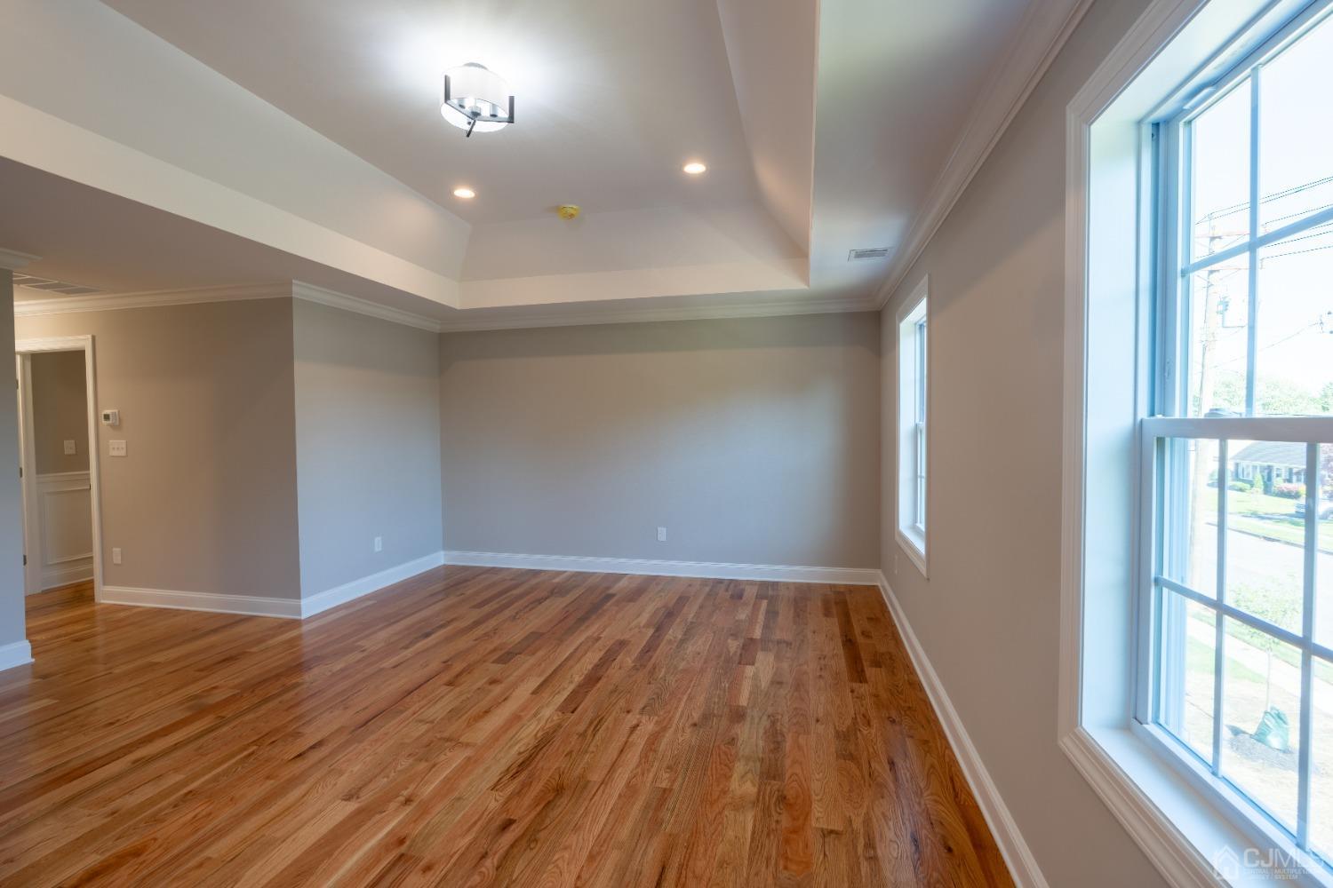 624 New Dover Road Colonia, NJ 07067 - Photo 22 of 29 wooden floor in an empty room with a window