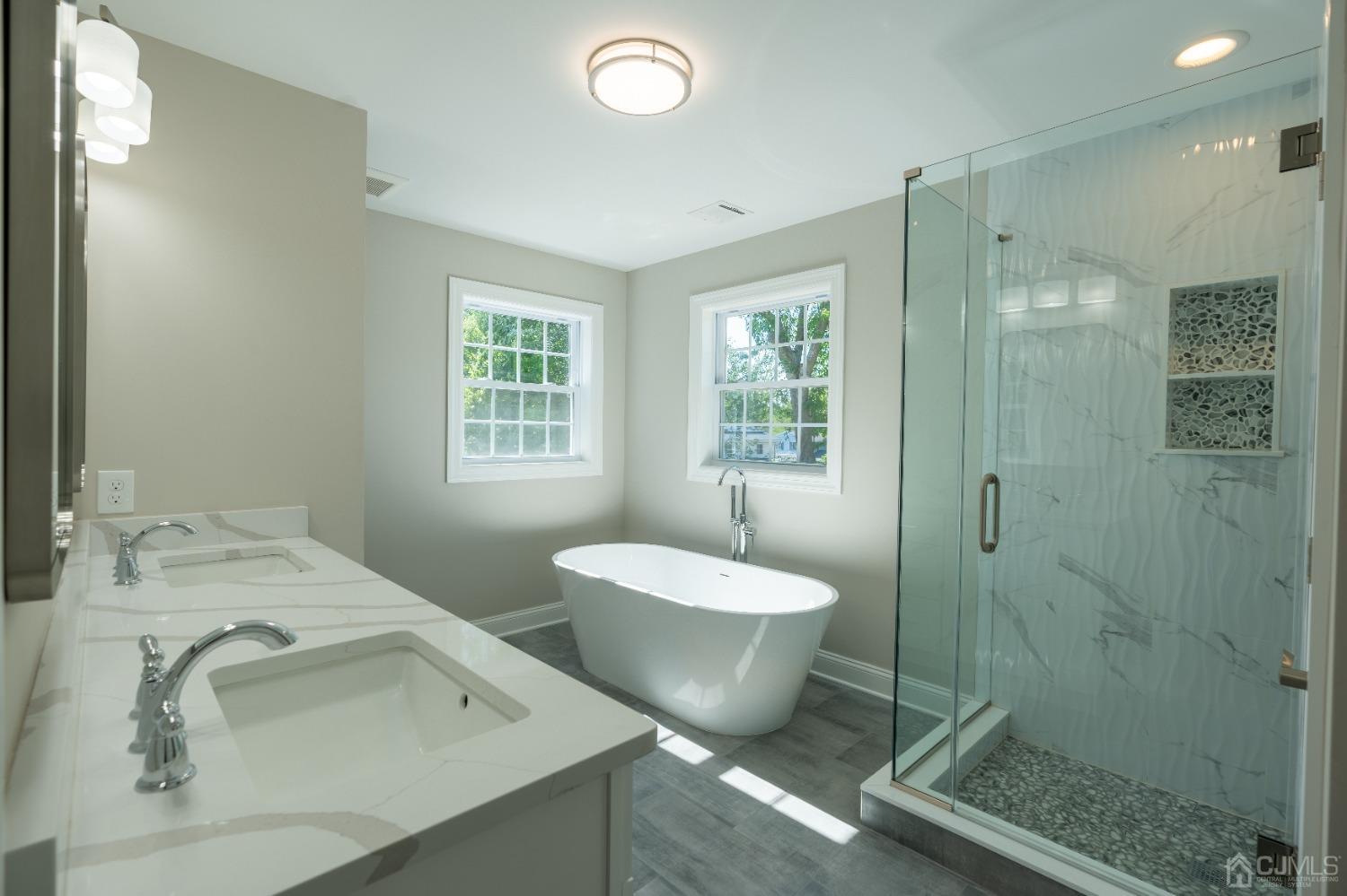 624 New Dover Road Colonia, NJ 07067 - Photo 24 of 29 a spacious bathroom with a double vanity sink toilet and shower