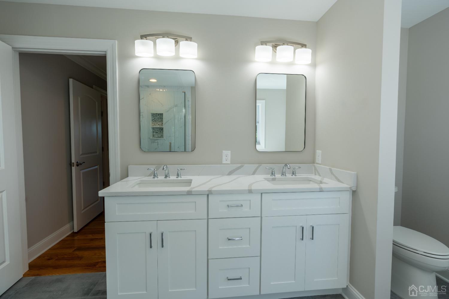 624 New Dover Road Colonia, NJ 07067 - Photo 25 of 29 a bathroom with double sink and a mirror