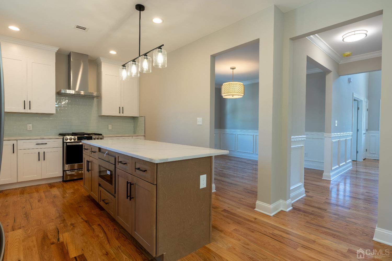 624 New Dover Road Colonia, NJ 07067 - Photo 4 of 29 a kitchen with a stove kitchen island and wooden floor