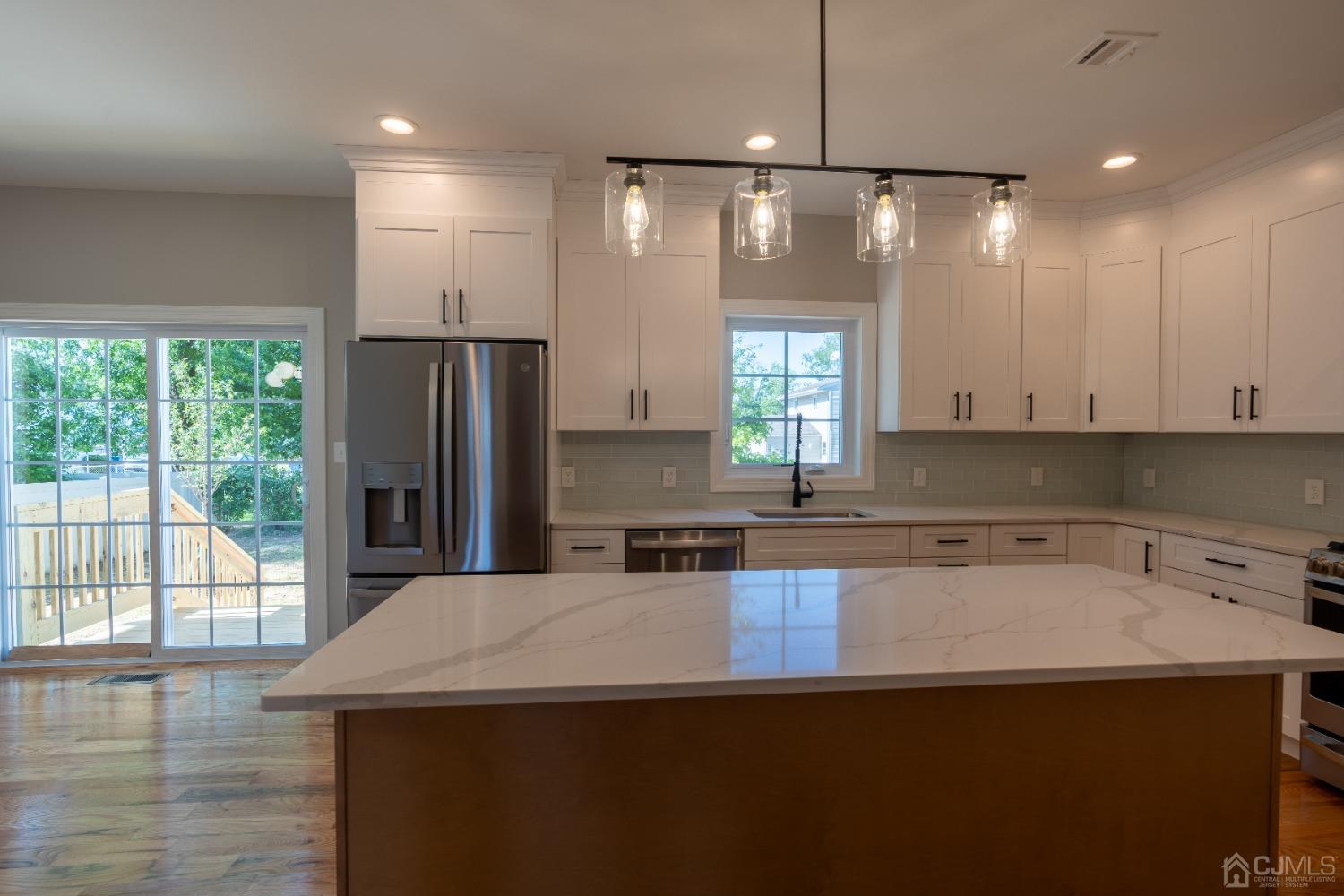 624 New Dover Road Colonia, NJ 07067 - Photo 5 of 29 a kitchen with a sink a refrigerator and window