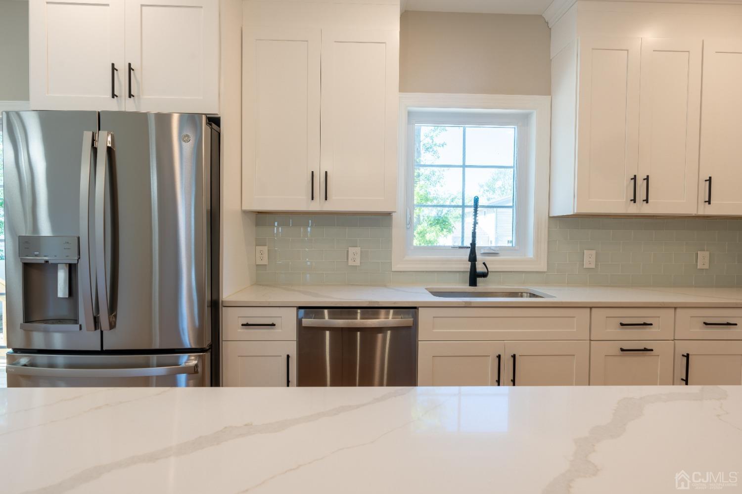 624 New Dover Road Colonia, NJ 07067 - Photo 6 of 29 a kitchen with stainless steel appliances a sink a stove a refrigerator and window