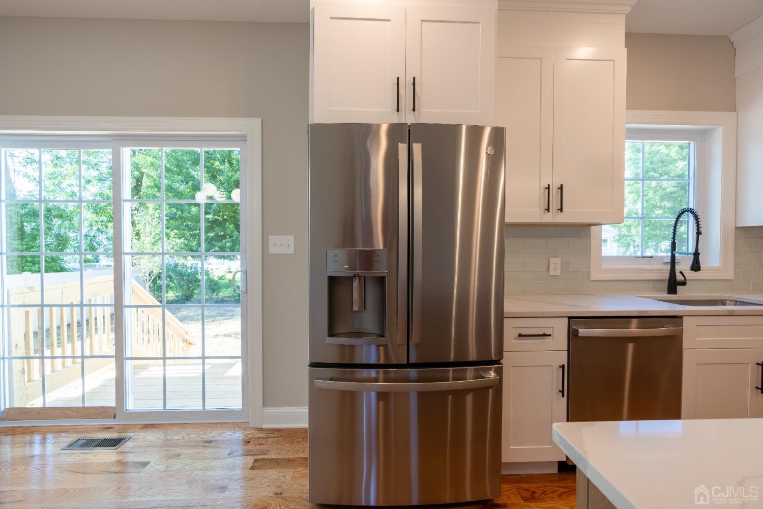 624 New Dover Road Colonia, NJ 07067 - Photo 8 of 29 a kitchen with stainless steel appliances a refrigerator and a sink