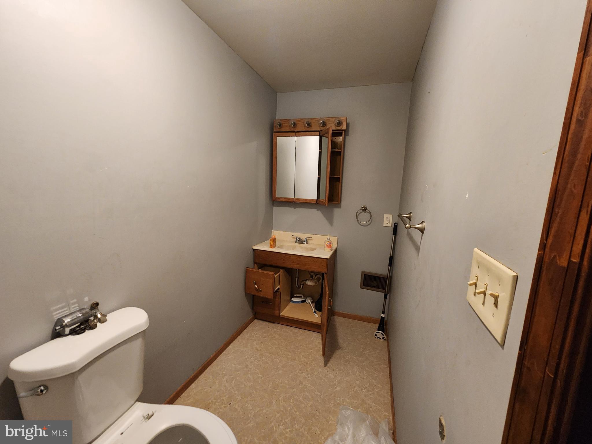 1182 Nanticoke Street Baltimore, MD 21230 - Photo 19 of 26 a bathroom with a toilet sink and mirror