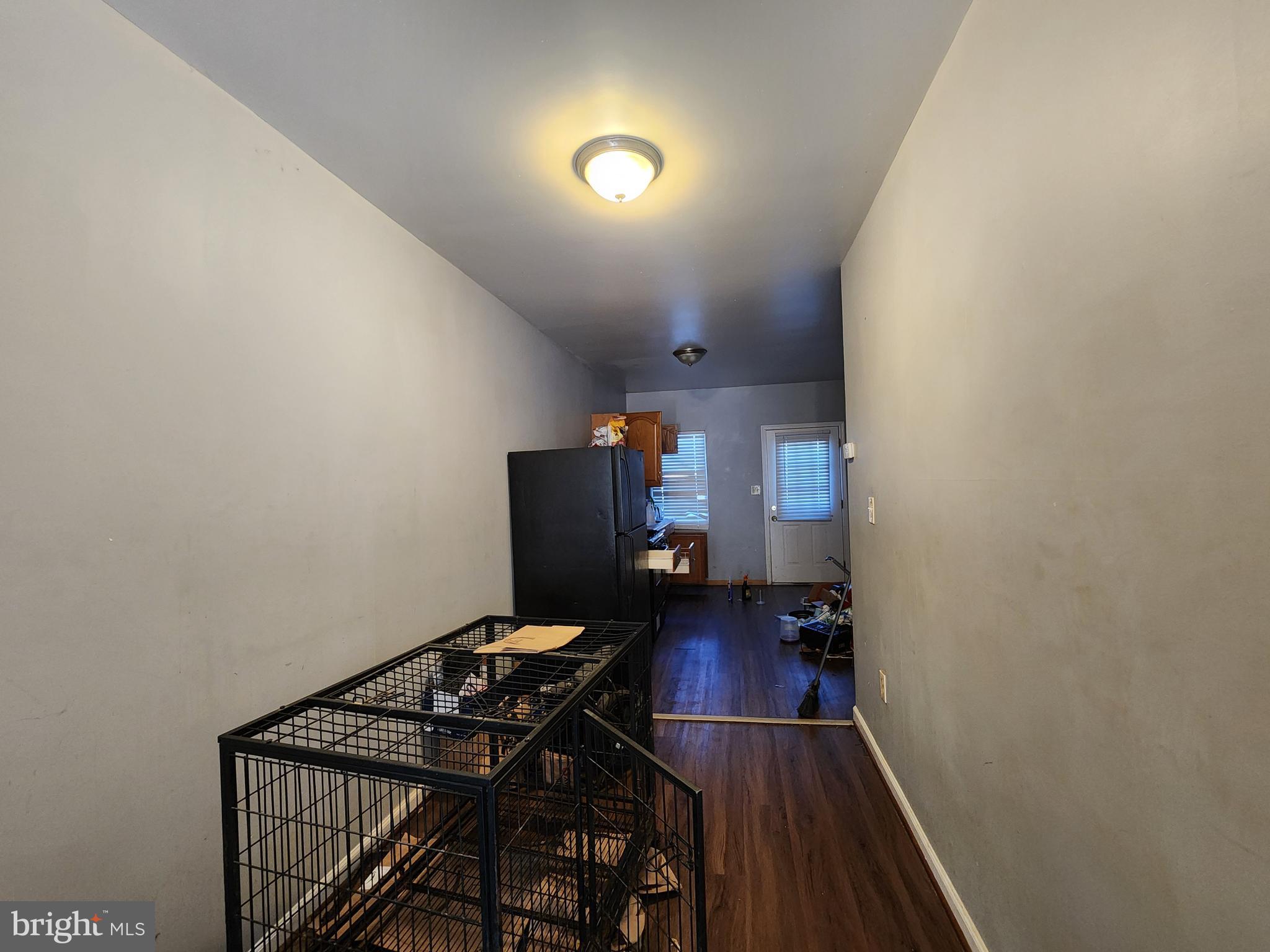 1182 Nanticoke Street Baltimore, MD 21230 - Photo 5 of 26 a view of a hallway with wooden floor and furniture
