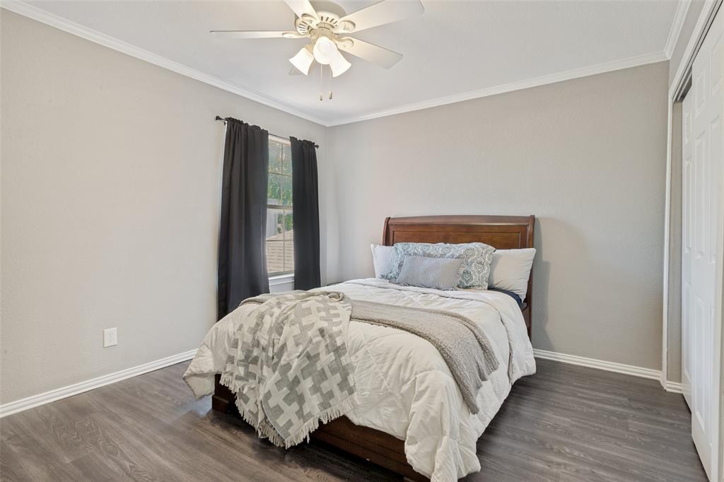 1228 Concho Drive Benbrook, TX 76126 - Photo 26 of 39 Spacious room featuring wood-finish flooring, light neutral wall tones, crown molding, and a ceiling fan with integrated lighting