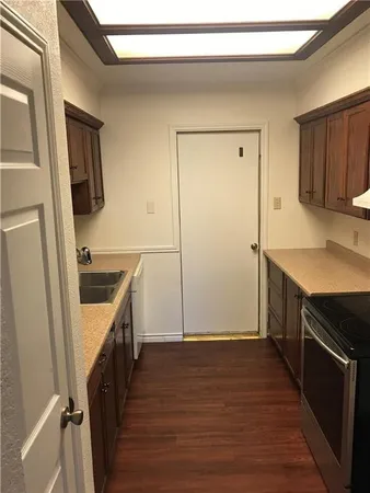 a kitchen with a sink stove and refrigerator