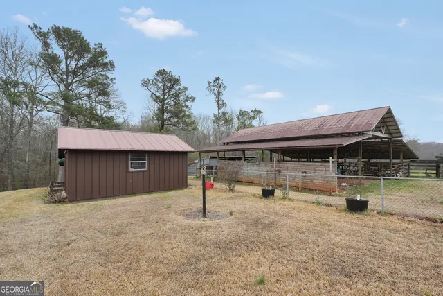 a view of a house with a wooden deck and a yard