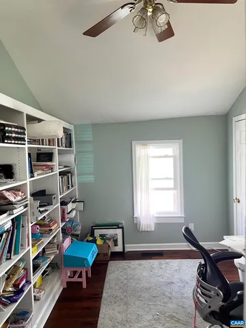 a bedroom with furniture and a book shelf