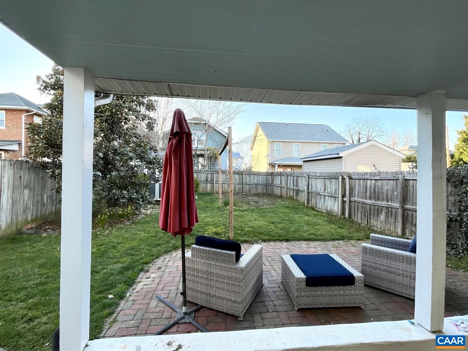 211 5th Street Northwest Charlottesville, VA 22903 - Photo 14 of 15 a view of a backyard with couches plants and wooden fence