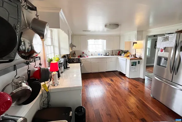 a kitchen with a refrigerator and a stove