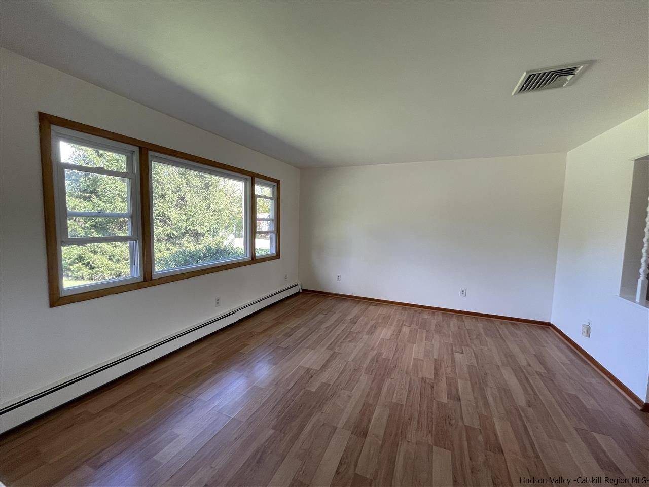 15 Old Lasher Road Saugerties, NY 12477 - Photo 5 of 18 an empty room with wooden floor and windows