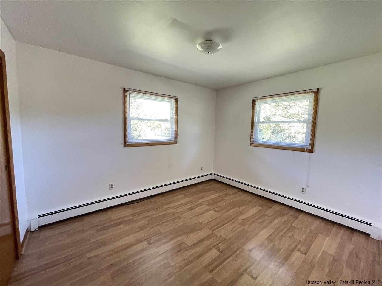 15 Old Lasher Road Saugerties, NY 12477 - Photo 8 of 18 an empty room with wooden floor and windows