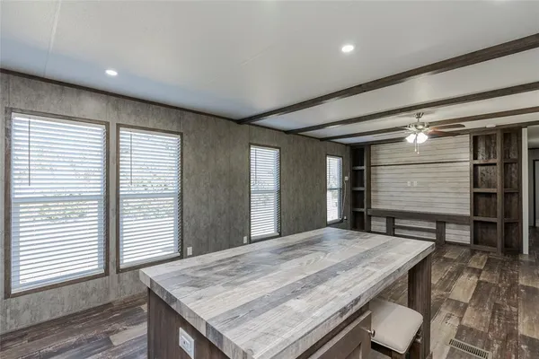 a view of kitchen with granite countertop window and wooden floor