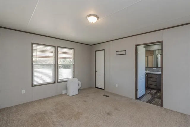 an empty room with windows and closet