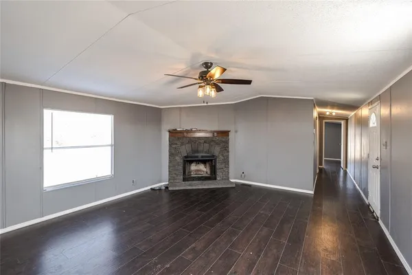 a kitchen with stainless steel appliances granite countertop a stove a sink dishwasher a refrigerator and white cabinets with wooden floor