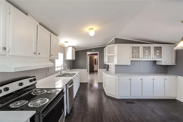 a view of a livingroom with a window and wooden floor
