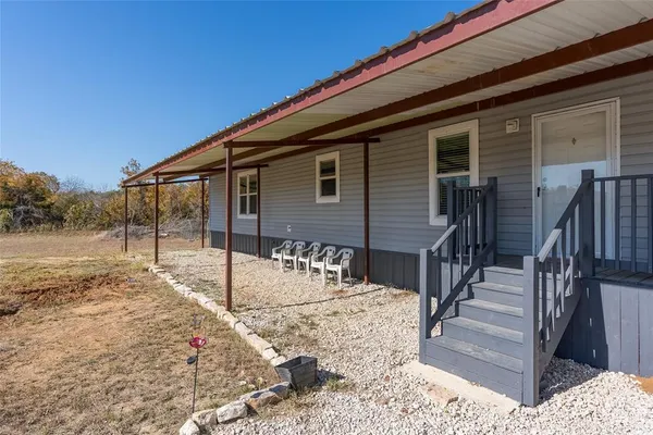 a view of a house with wooden fence