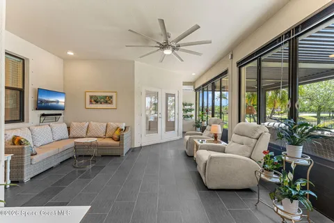 a living room with furniture and large windows