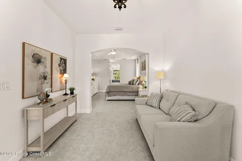 a living room with furniture and a chandelier