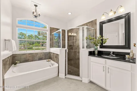 a white bath tub sitting next to a bathroom sink