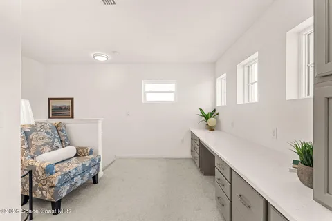 a bedroom with a bed and a potted plant