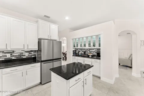 a kitchen with granite countertop a sink and cabinets