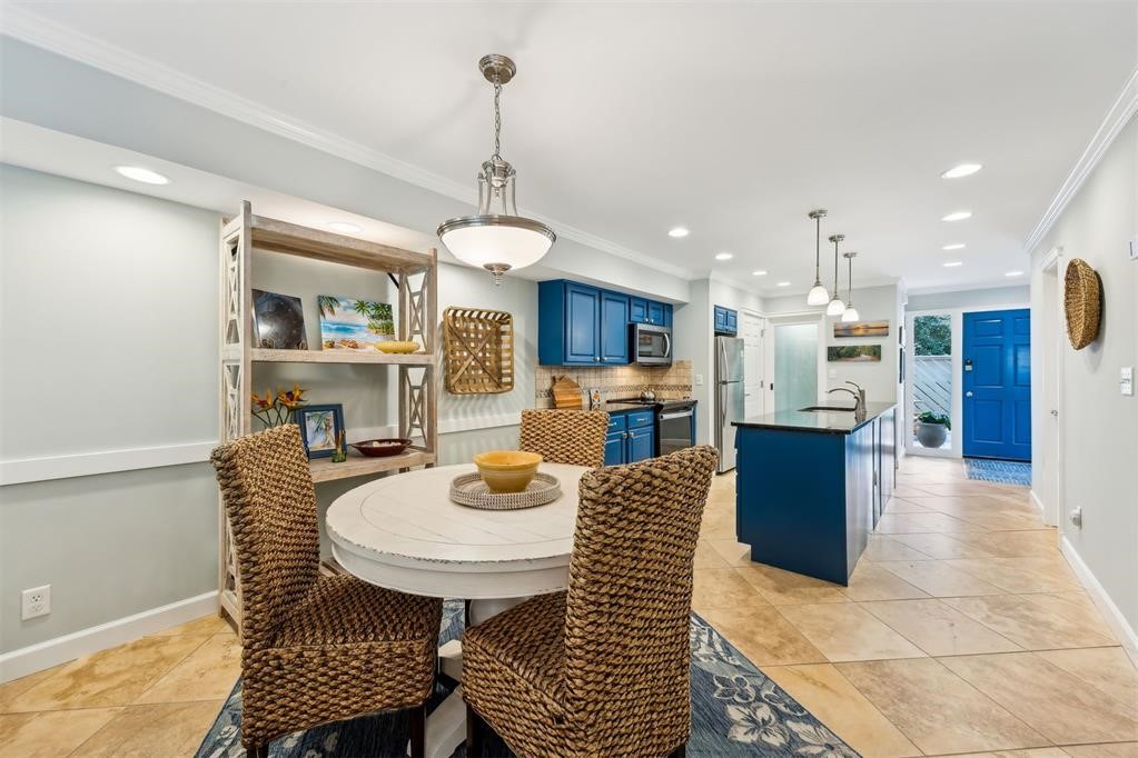 3033 Sea Marsh Road Fernandina Beach, FL 32034 - Photo 13 of 37 a view of a dining room and livingroom with furniture wooden floor a chandelier