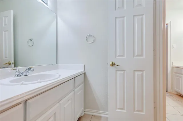 a bathroom with a sink vanity and a mirror