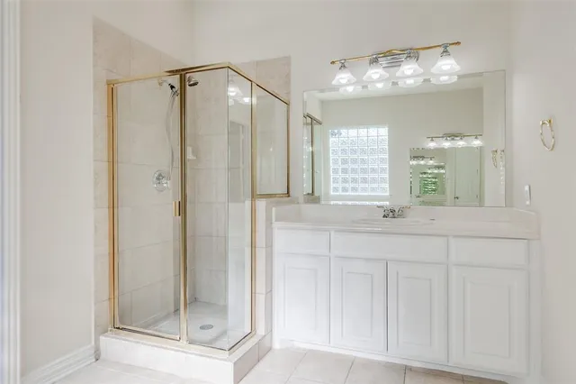 a bathroom with a shower sink and mirror