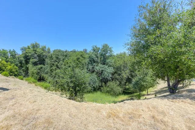 an aerial view of residential houses with outdoor space and river view