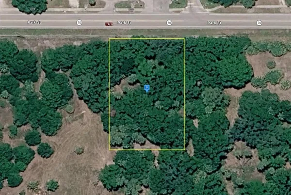 an aerial view of a house with a yard and garden